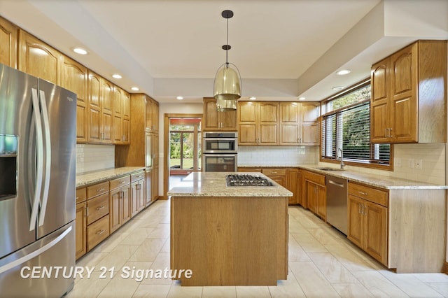 kitchen featuring decorative light fixtures, a kitchen island, a healthy amount of sunlight, and stainless steel appliances