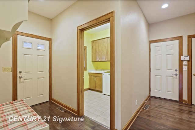 foyer with dark hardwood / wood-style floors and sink