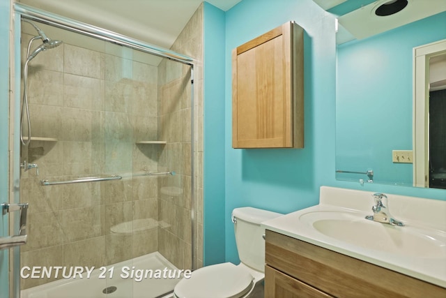 bathroom featuring vanity, toilet, and an enclosed shower