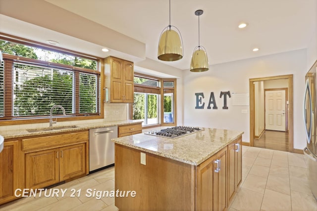 kitchen with pendant lighting, backsplash, sink, a kitchen island, and stainless steel appliances