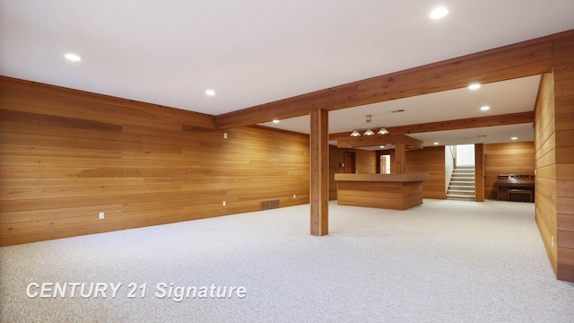 basement with light colored carpet and wooden walls