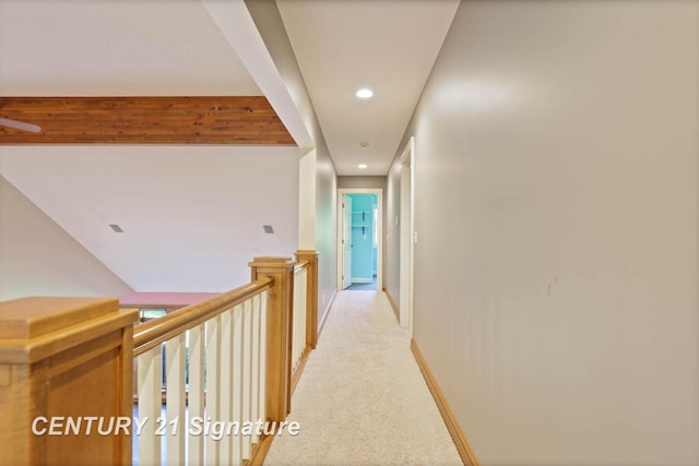 hall featuring beamed ceiling and light colored carpet