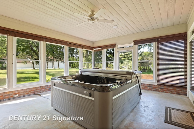 unfurnished sunroom with ceiling fan, a healthy amount of sunlight, a jacuzzi, and wooden ceiling