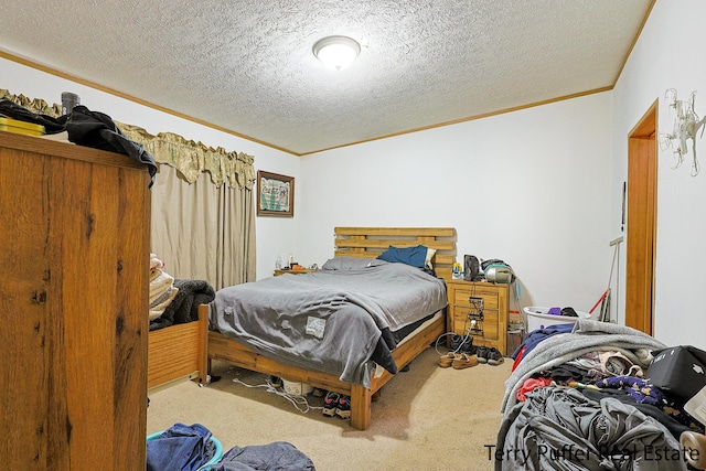 bedroom with crown molding, carpet floors, and a textured ceiling