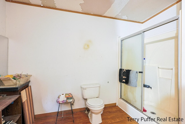 bathroom featuring hardwood / wood-style floors, toilet, and an enclosed shower