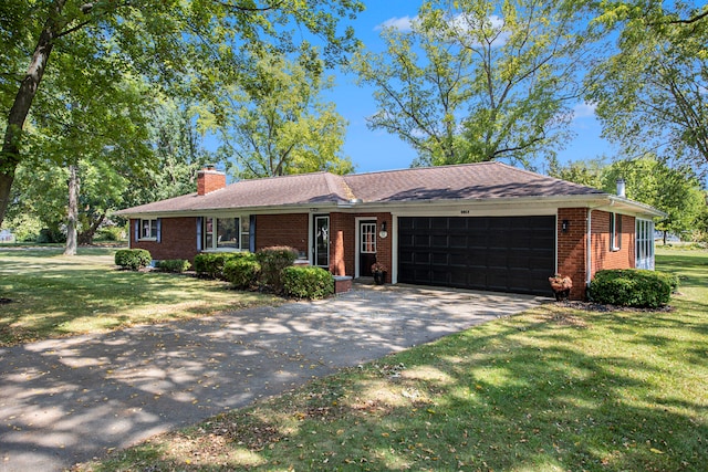 ranch-style home featuring a garage and a front lawn