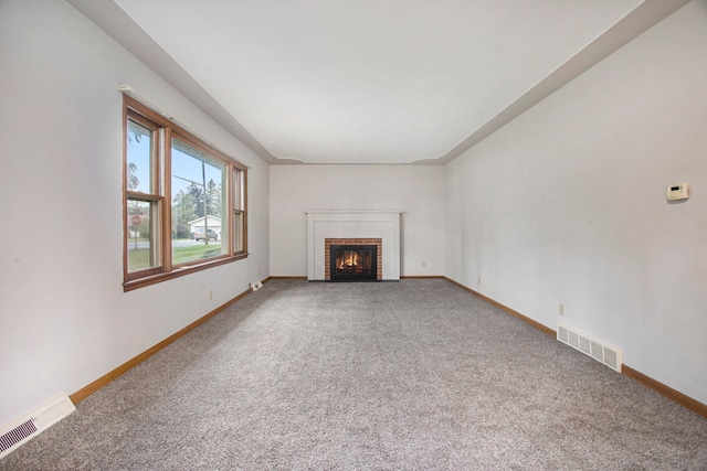 unfurnished living room with carpet and a fireplace