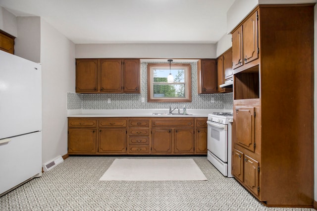 kitchen featuring backsplash, white appliances, sink, and range hood