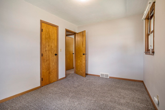 unfurnished room with carpet flooring