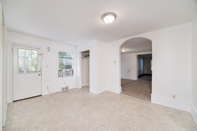 carpeted spare room featuring cooling unit