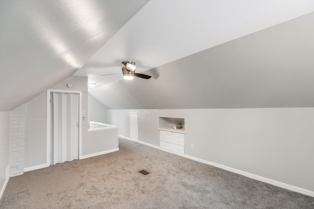 additional living space with carpet floors, ceiling fan, and lofted ceiling