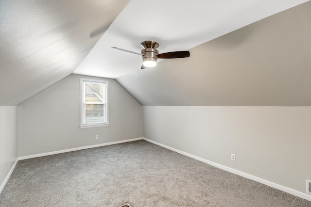 additional living space with carpet, ceiling fan, and vaulted ceiling