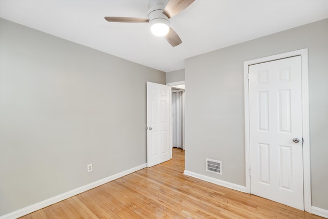 unfurnished bedroom with ceiling fan and light hardwood / wood-style floors