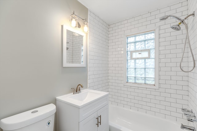 full bathroom with vanity, toilet, and tiled shower / bath combo