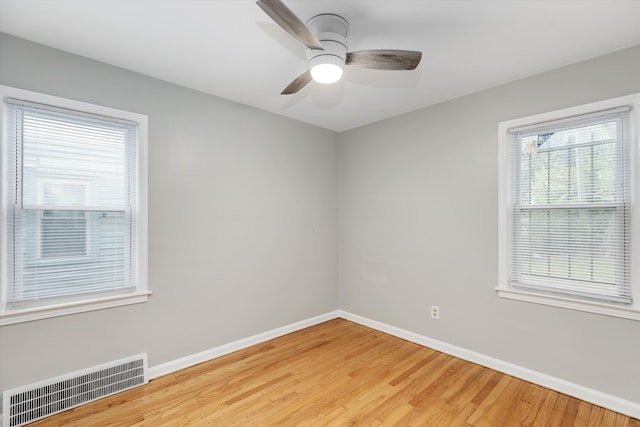 unfurnished room with ceiling fan and wood-type flooring