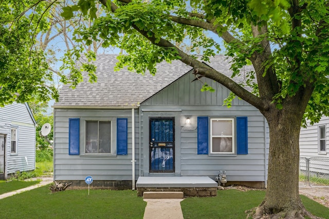 bungalow-style house featuring a front yard