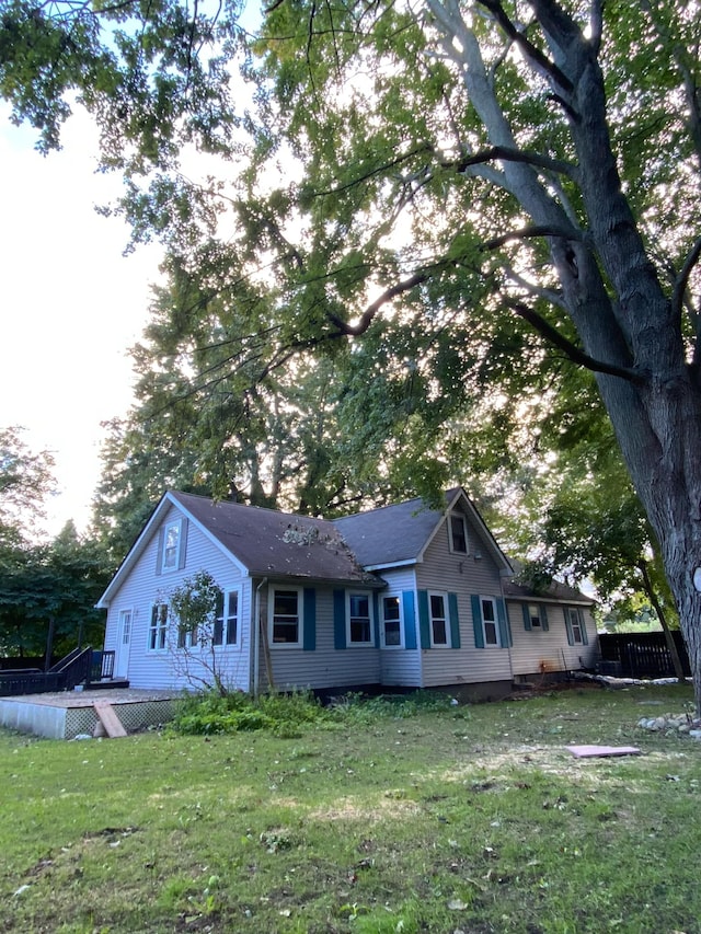 view of front of house featuring a front yard and a wooden deck