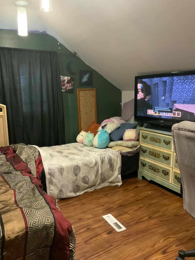 bedroom featuring wood-type flooring and lofted ceiling