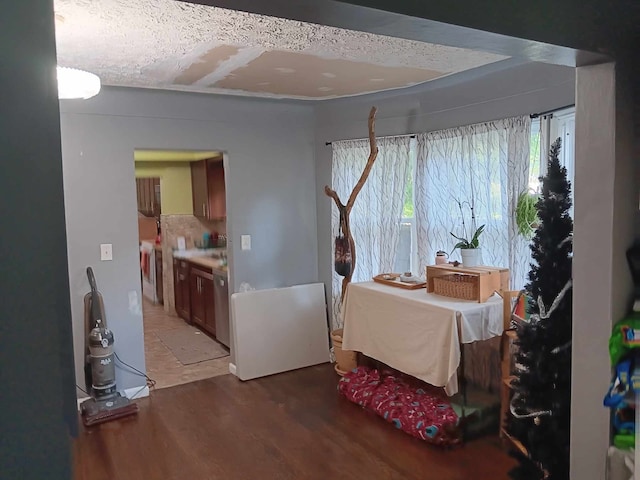 interior space with hardwood / wood-style flooring and a textured ceiling