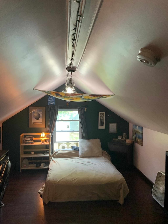 bedroom featuring wood-type flooring and vaulted ceiling