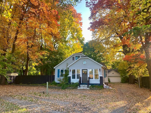 view of front of property with a garage and an outdoor structure