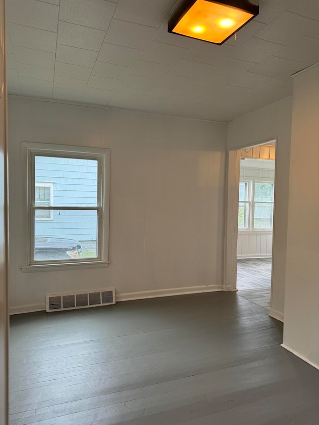 unfurnished room featuring dark hardwood / wood-style flooring