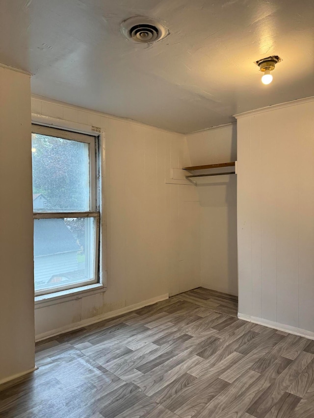 unfurnished bedroom with a closet and hardwood / wood-style flooring