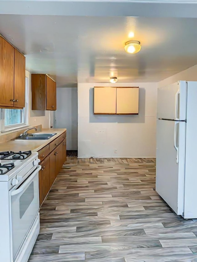 kitchen featuring white appliances and sink