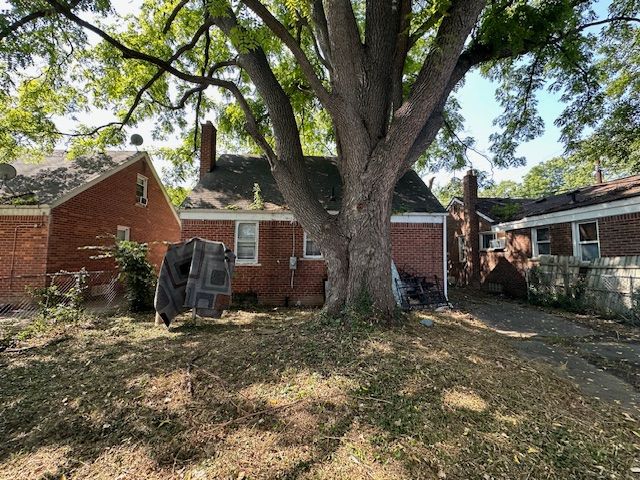 18538 Trinity St, Detroit, MI 48219 - view of home's exterior featuring brick siding and a chimney