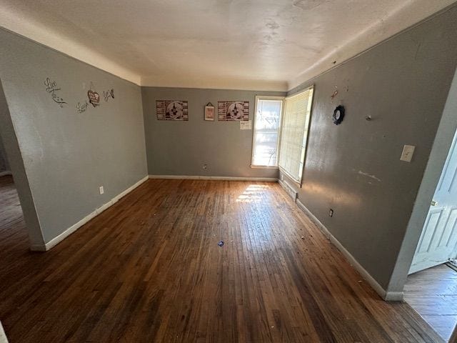 spare room with dark hardwood / wood-style floors