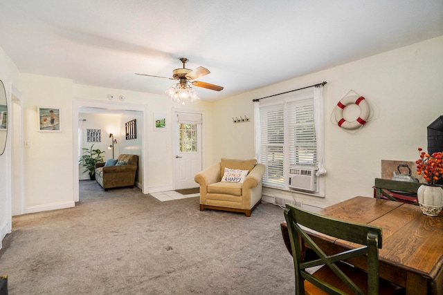 living area featuring ceiling fan, cooling unit, and light colored carpet