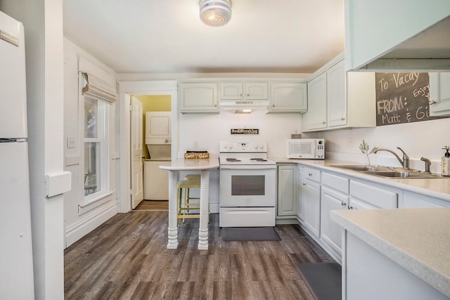 kitchen with sink, white cabinets, dark wood-type flooring, and white appliances