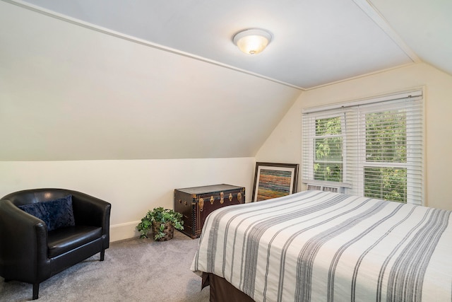 bedroom featuring lofted ceiling and light carpet