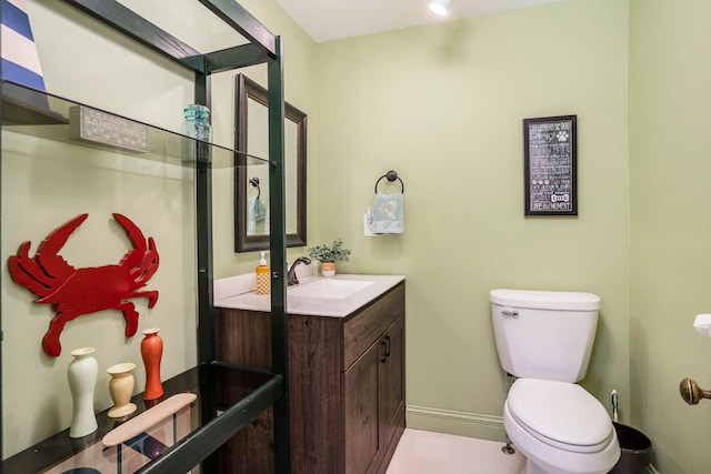 bathroom featuring tile patterned flooring, vanity, and toilet