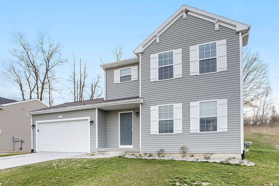 view of front facade with a garage and a front lawn