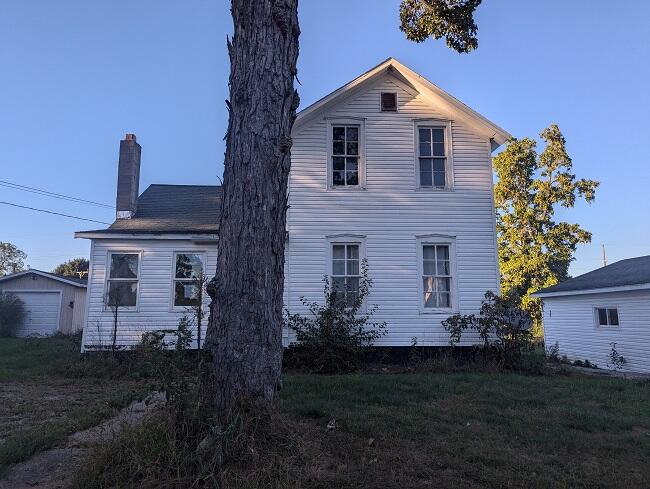 back of property featuring a lawn