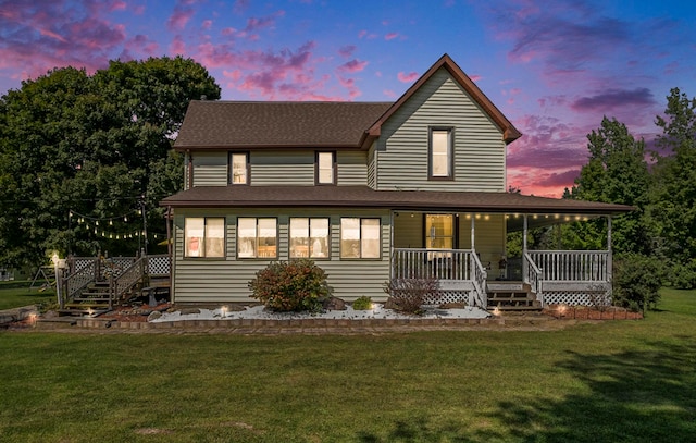 view of front of house with a lawn and covered porch