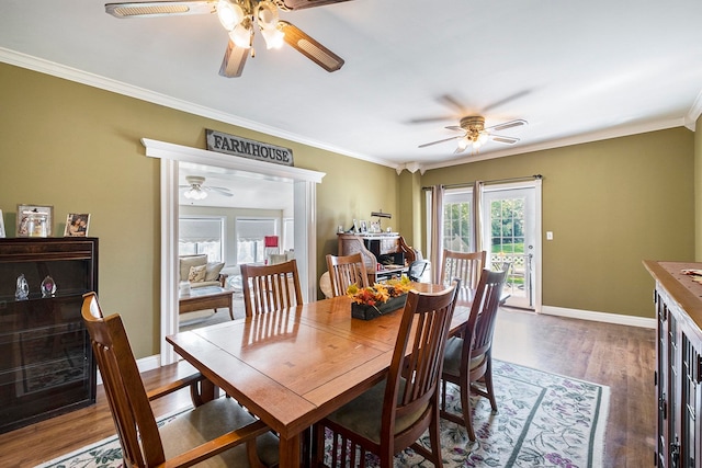 dining room featuring crown molding, ceiling fan, and dark wood-type flooring