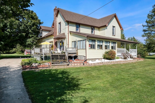 view of front of property with covered porch and a front yard