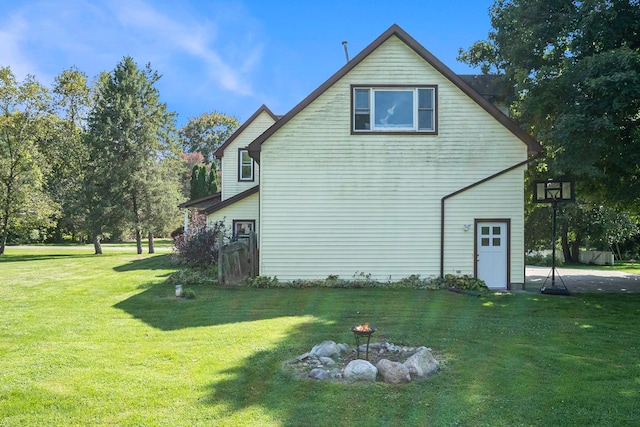 view of side of home featuring a yard