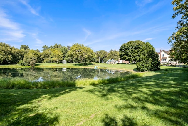 surrounding community with a yard and a water view