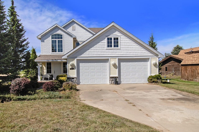 view of front of property with a garage and a front yard