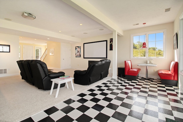 carpeted cinema featuring beamed ceiling