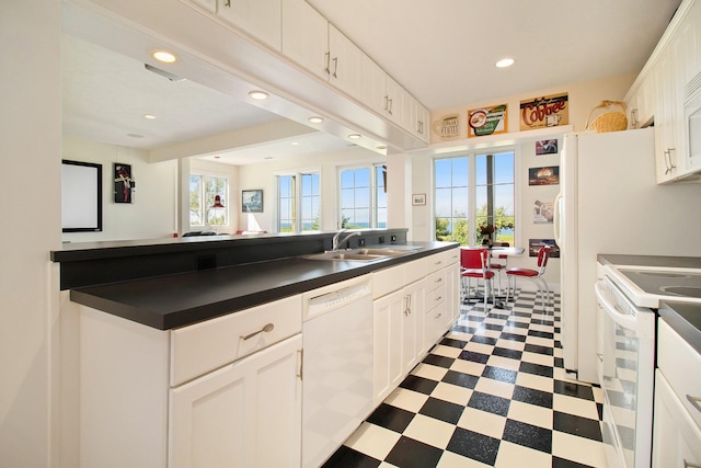 kitchen with white cabinets, white appliances, and sink