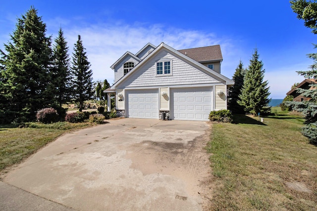 view of front facade with a garage and a front lawn