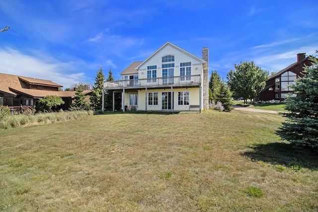 rear view of property featuring a yard