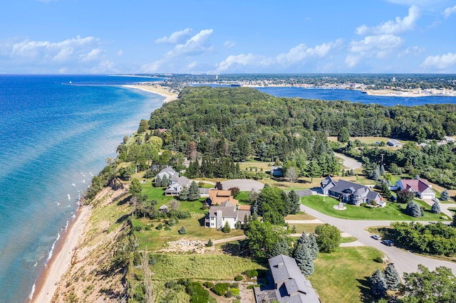 birds eye view of property featuring a water view and a beach view