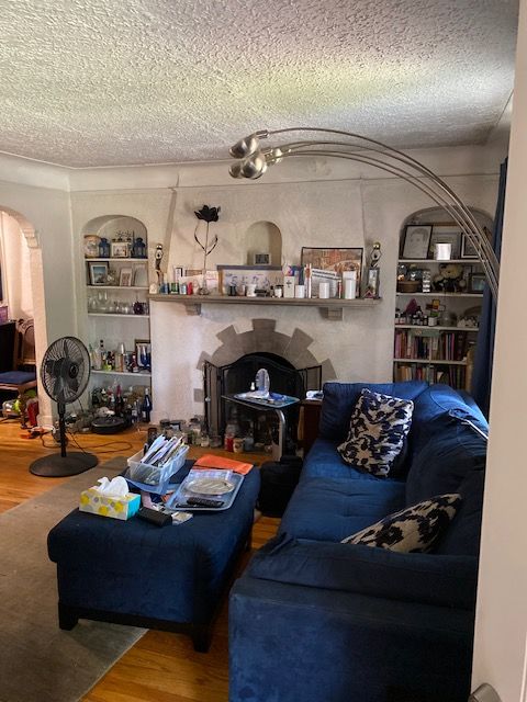 5051 Bishop St, Detroit, MI 48224 - living area with wood finished floors, arched walkways, and a textured ceiling