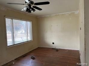 unfurnished room with ceiling fan, dark hardwood / wood-style flooring, a healthy amount of sunlight, and ornamental molding