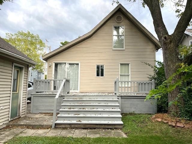 back of property featuring a deck